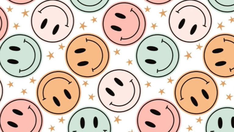 Pattern of colorful smiley faces with star accents on a white background
